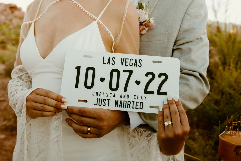 Red Rock Desert & Neon Vegas Lights. Newlyweds get a custom Las Vegas license plate made with their name, date of their elopement. 