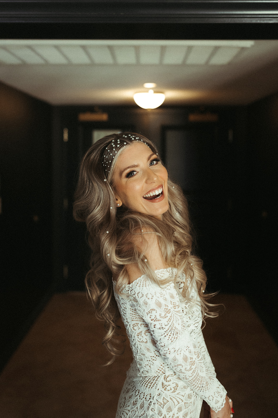 The bride smiling as she gets ready to leave for ceremony