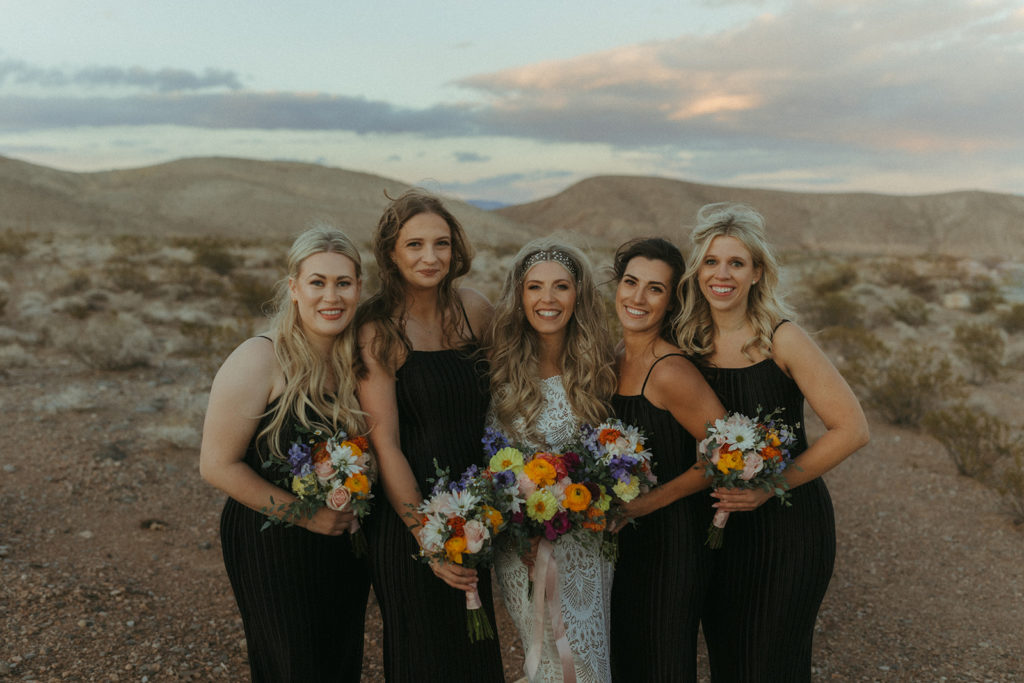 The bride poses with her bridesmaids 