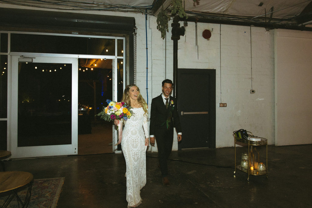 Newlyweds enter the venue for a room reveal 