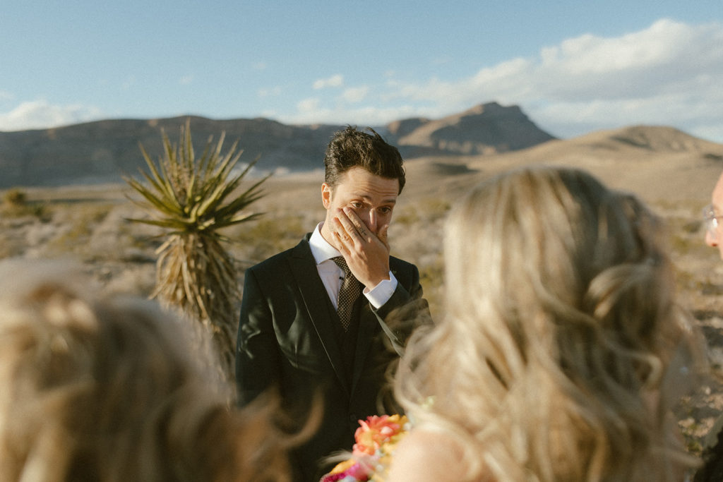 The groom in awe at the altar as he sees the bride for the first time at ceremony