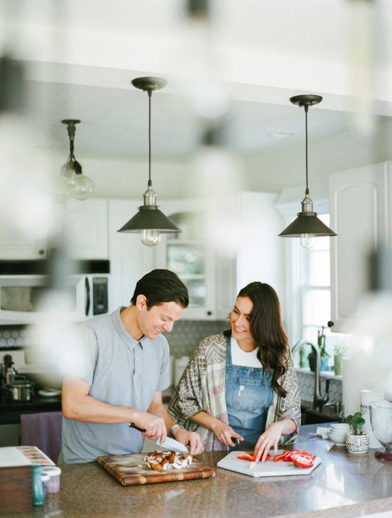 Unique Valentines Day Gift & Date Ideas. Couple cooking together in the kitchen 