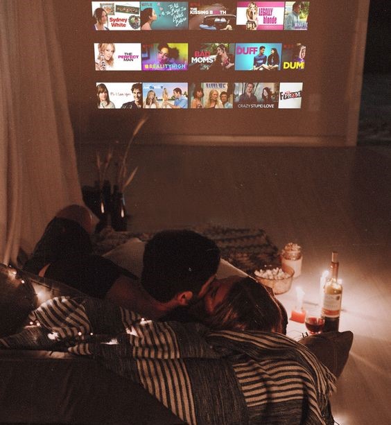 Unique Valentines Day Gift & Date Ideas. At home movie date night in the living room with candles and wine