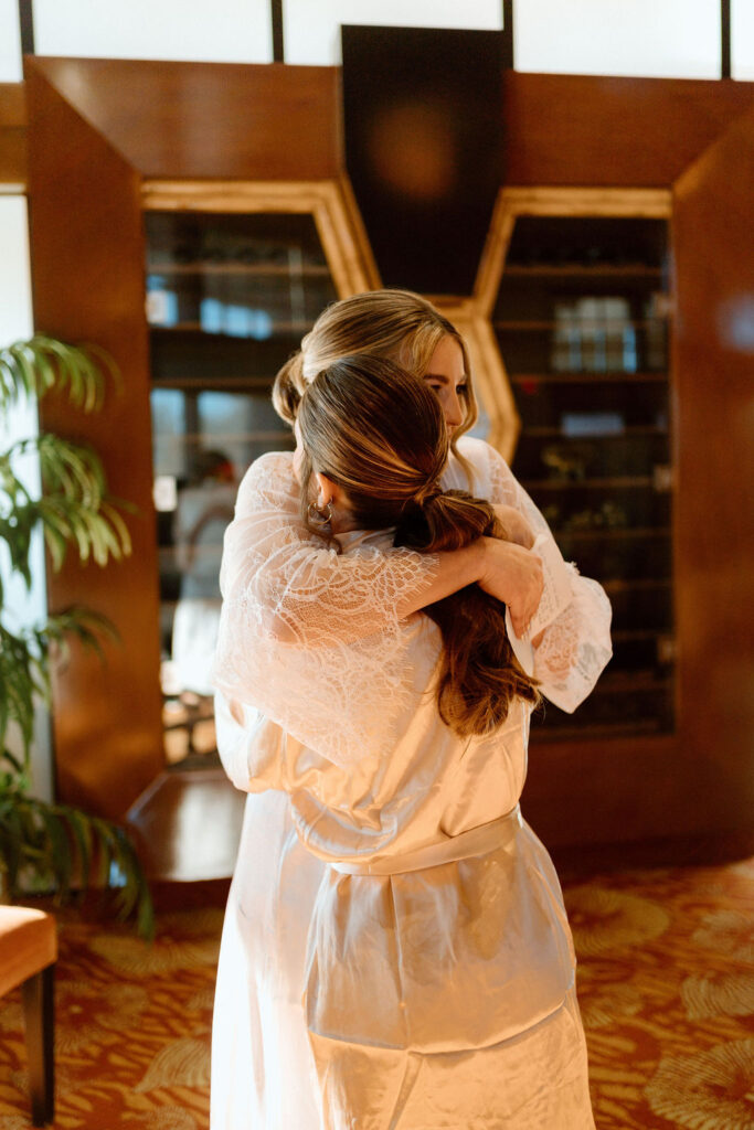 Bride hugging her bridesmaid close