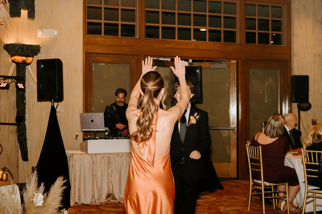 Bridesmaid and a groomsmen dancing on the dance floor. 