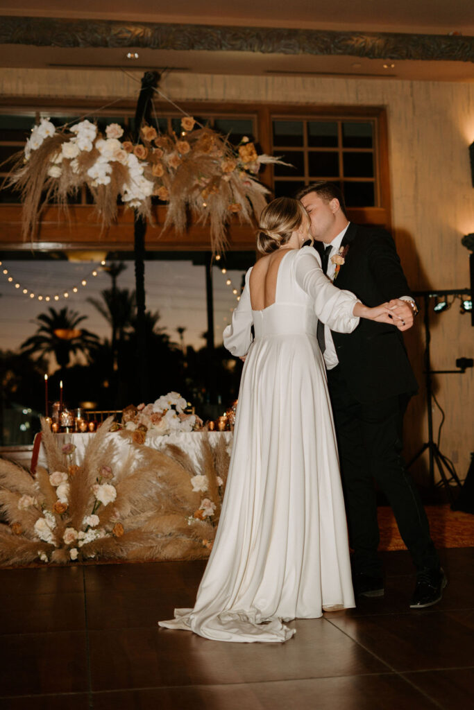 Bride and groom kiss during their first dance. 
