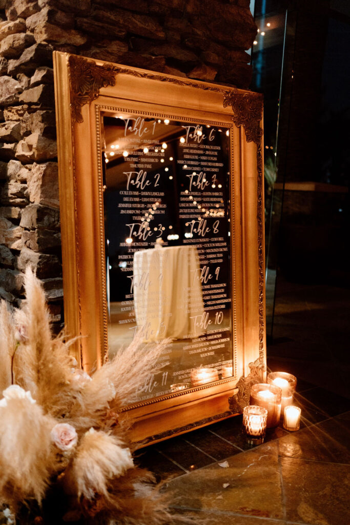 Guest seating chart on a beautiful large mirror. 