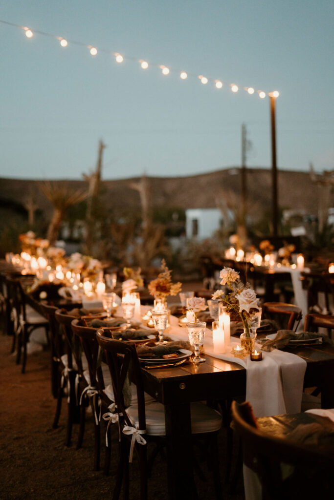 Candles, Pampas, & Romance at Cactus Joe's Bistro lights lit up with a wide shot of the reception tables decorated with simple florals and candles. 