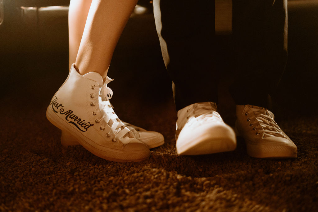 Close up of the bride and grooms converse that are personalized and say "Just Married" along the side. 