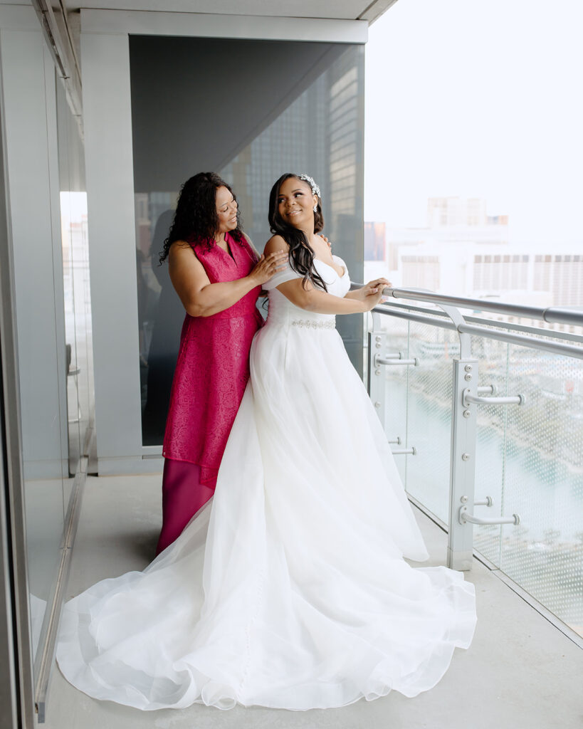 Mother of the bride poses with the bride