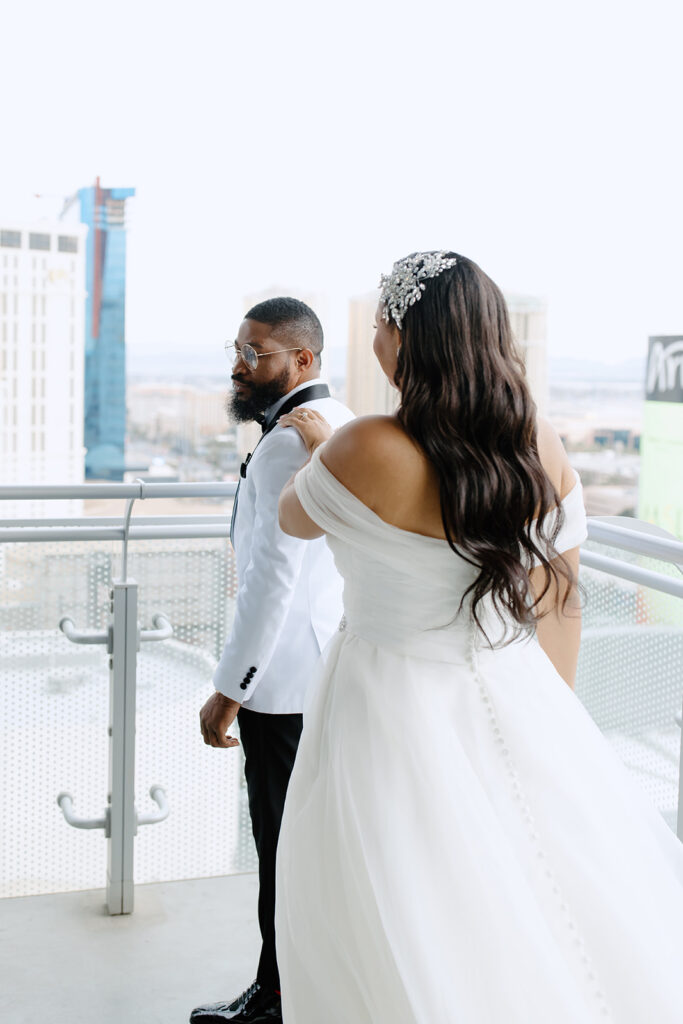 Bride taps the groom on his shoulder for him to turn around for the first look 