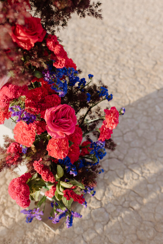 Up close photo of an array of colorful flowers that are placed along the arch 