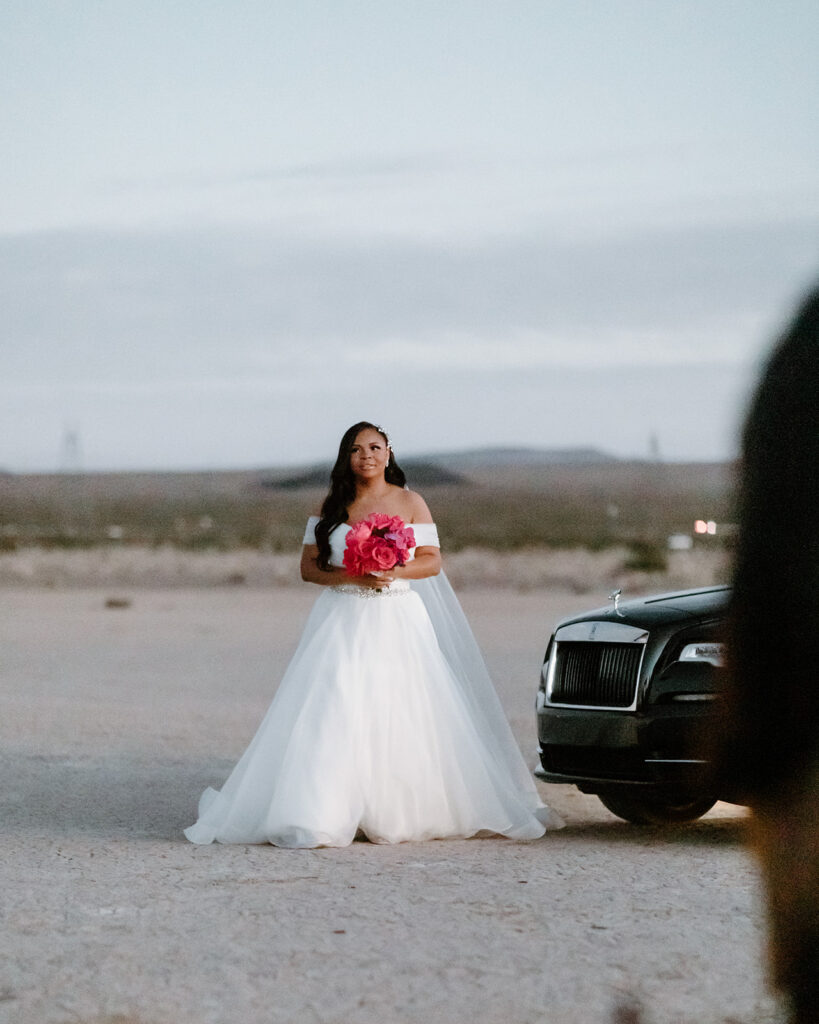 Colorful & Romantic Elopement on the Dry Lake. Bride steps out of a Rolls Royce to walk down the aisle 