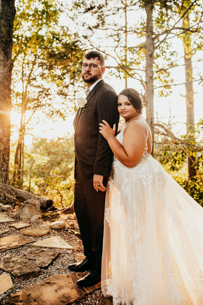 Rolling Hills and Tennessee Whiskey. Newlyweds take a photo during sunset in the knolls of the magnolia venue 