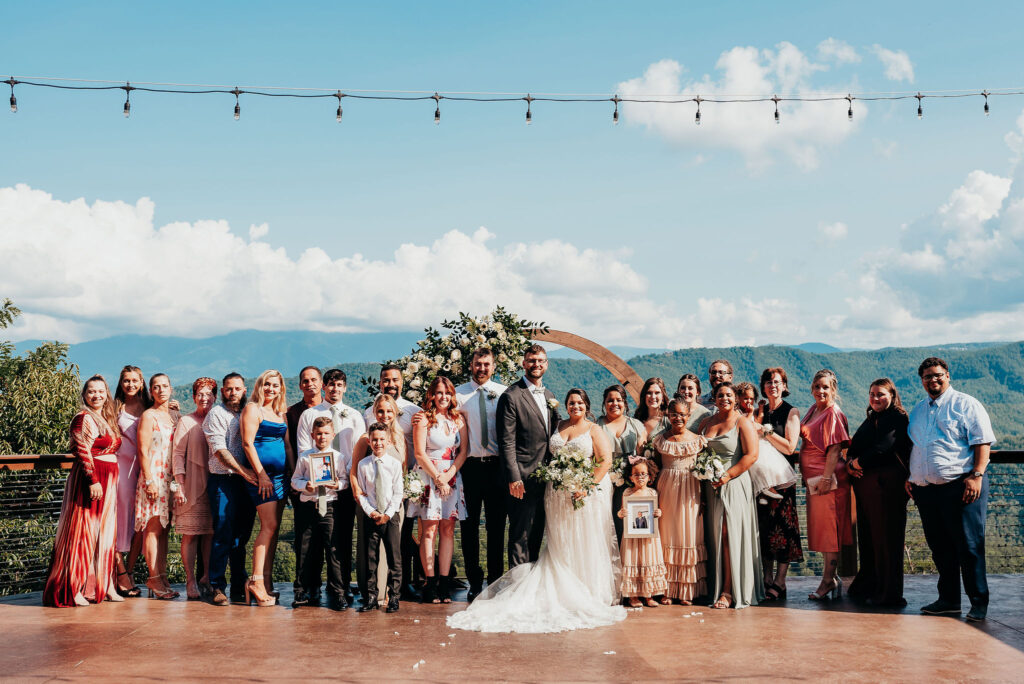 Rolling Hills and Tennessee Whiskey. Friends and family gather around bride and groom at the altar for a big photo