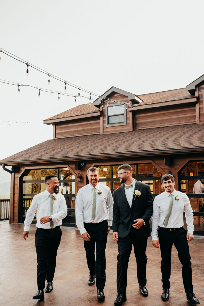 Groom and groomsmen walk the grounds of the magnolia venue 