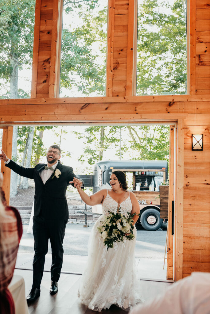 Newlyweds walk into their grand entrance at reception 