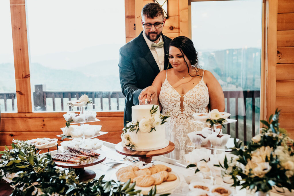Rolling Hills and Tennessee Whiskey. Newlyweds cutting their cake 