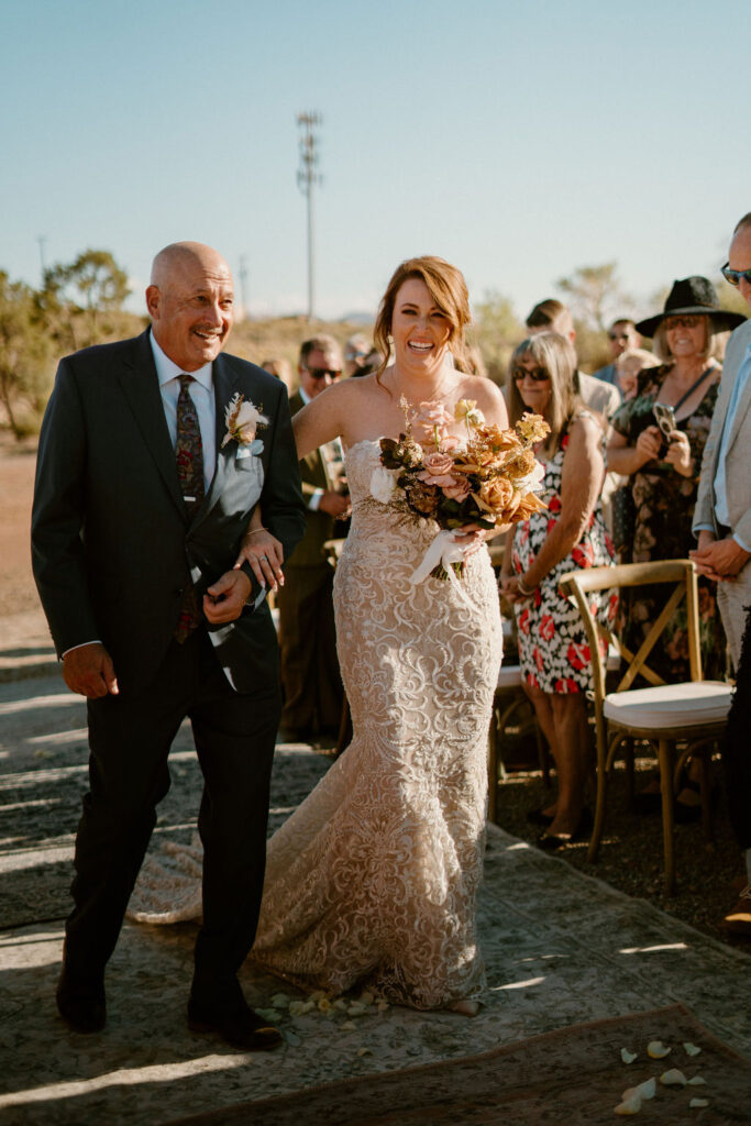 Bride and Father walking down the isle with guests