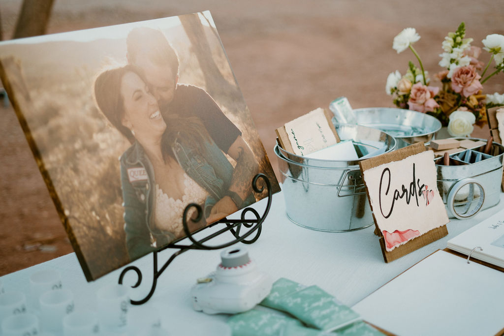 Engagement photo of couple with card metal bucket and table decoration. 