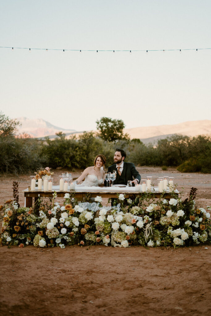 Bride and Groom enjoying their reception at the his and her table. 