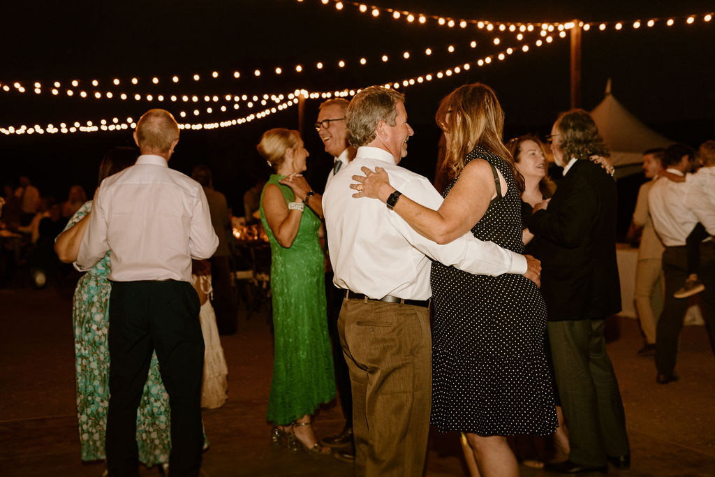 Wedding guests enjoy an evening on the dance floor under the desert stars. 