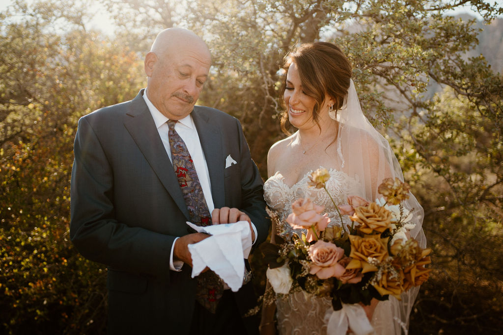Bride with her father reading a personal letter. 