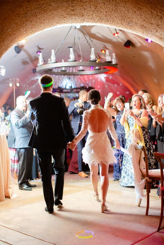 All Things Wedding Weekend. Newlyweds walking into their after party in a cave