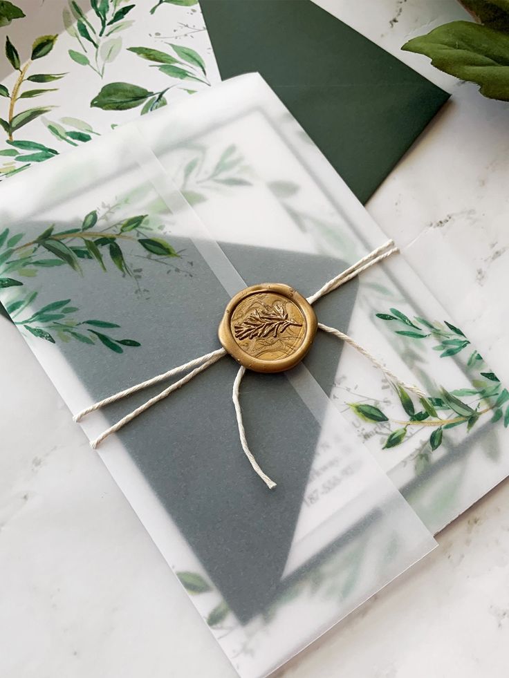 Greenery with a golden wax seal wedding invitation suite. 