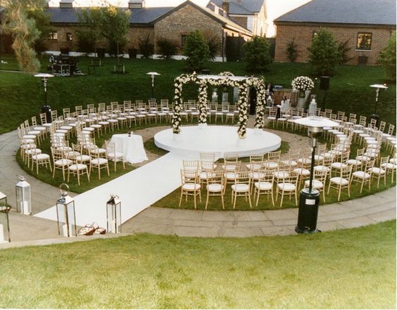 Aisle: Circle Or Runway? Circular runway with circle raised stand and floral arch in the center. 