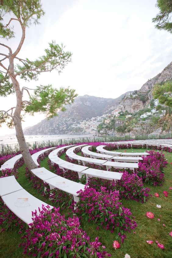 Aisle: Circle Or Runway? Circular runway with marble benches and deep purple floral display. 