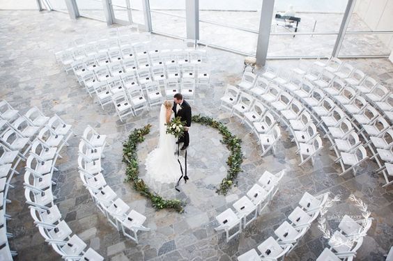Aisle: Circle Or Runway? Circular runway with a bright white chairs and the bride and groom in the cetner. 