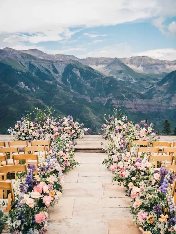 Aisle: Circle Or Runway? Mountain overlook with beautiful pastel floral display along the aisle. 