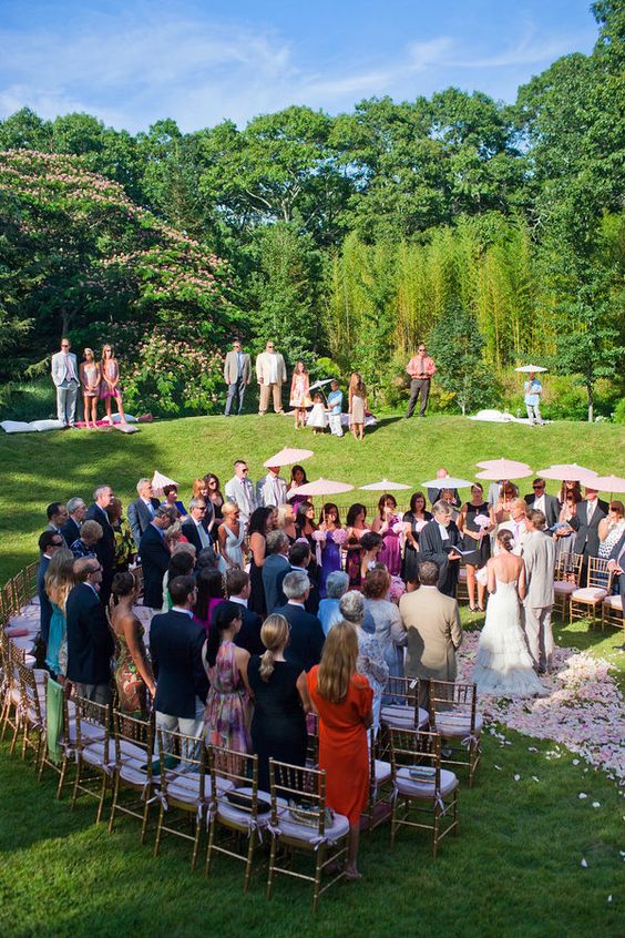Bride and groom in the center of a circular runway the guest facing them. 