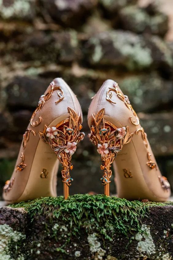 Themed high heels the color of pink champagne and vines and pink flowers intertwining up the shoes. 