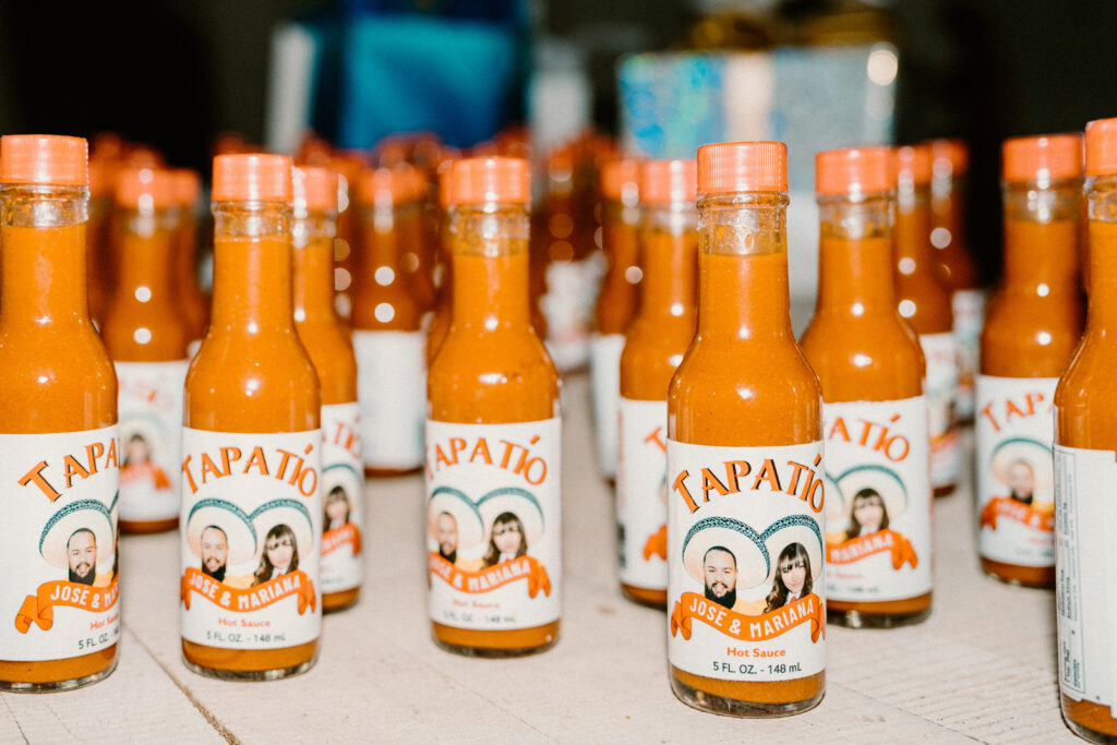 Unveiling the Magic: The Art of Styling a Themed Wedding Tapatio personalized wedding favors with the bride and grooms face on the bottle. With their names and wedding date. 