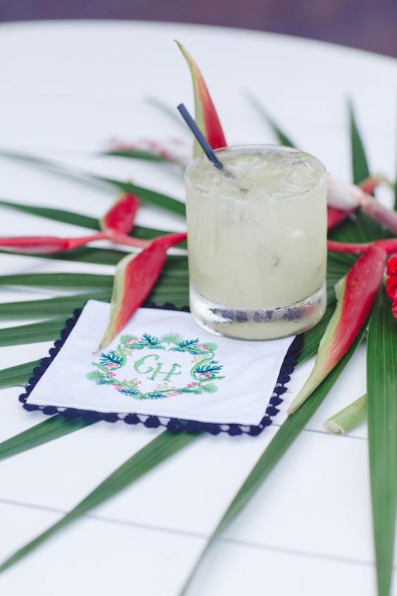 5 Trendiest Bach Party Themes Cocktail decorated with tropical leaves and personalized napkin. 