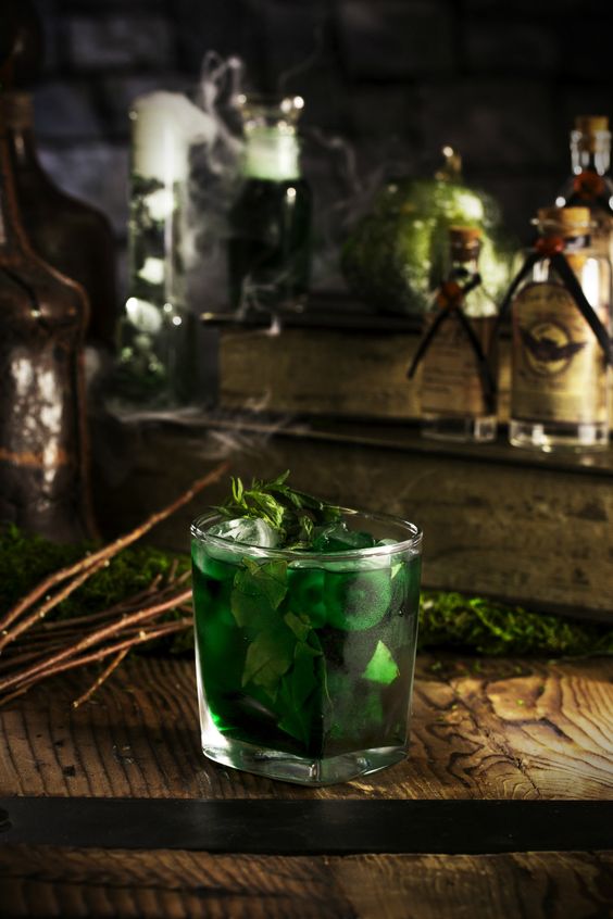 Unveiling the Magic: The Art of Styling a Themed Wedding a rich dark green julep with bourbon and spearmint. 