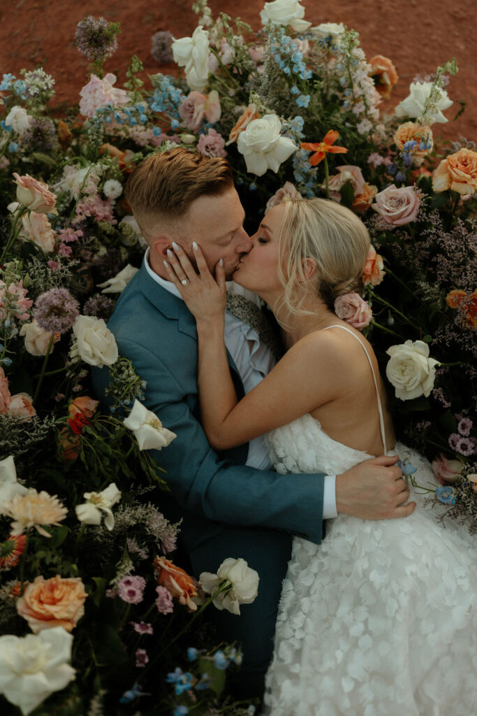 The Ultimate Garden Party Wedding: Your Dream Day Blossoms Here! Couple laying in bed of florals 