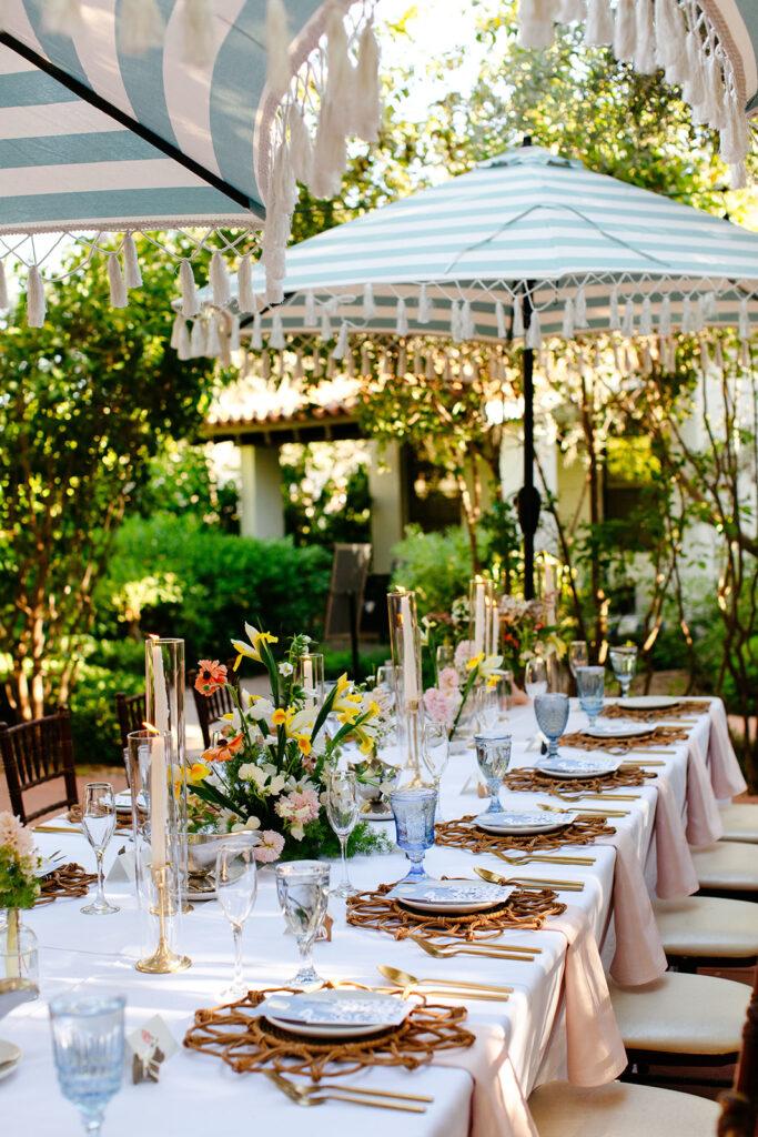 The Ultimate Garden Party Wedding: Your Dream Day Blossoms Here! Garden Party wedding tablescape with white and blue umbrellas, candles, and floral centerpieces 