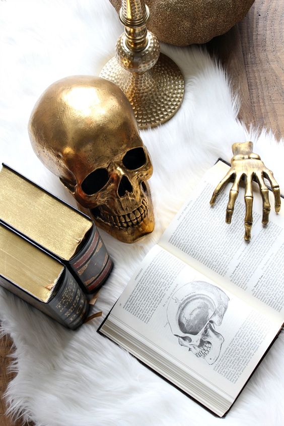 Elevate Your Halloween: Modern Decor Ideas for a Stylish Spookfest! Gold skull with books 