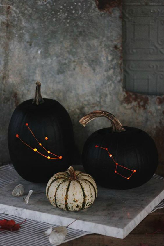 Black pumpkins with constellation carvings 