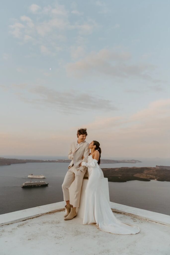 Love Beyond Borders: Top Wedding Destinations of 2024 That Will Steal Your Heart! Santorini, Greece Elopement with water view 