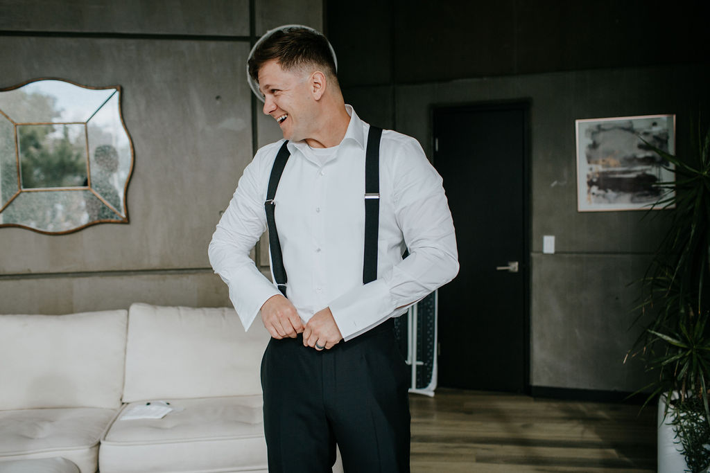 Unleash the Magic: Why Your First Look Should Steal the Show. Groom laughing getting ready for first look. 