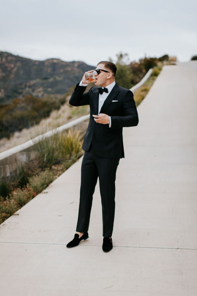 Unleash the Magic: Why Your First Look Should Steal the Show. Groom taking drink before first look 
