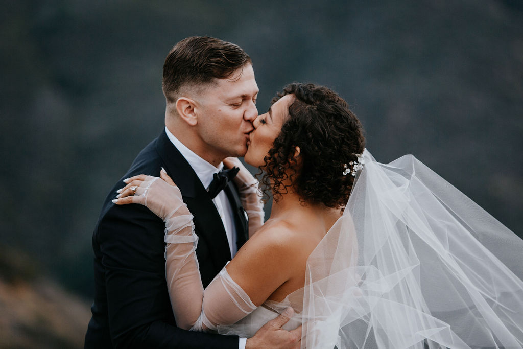 Unleash the Magic: Why Your First Look Should Steal the Show. Bride and groom's first kiss 