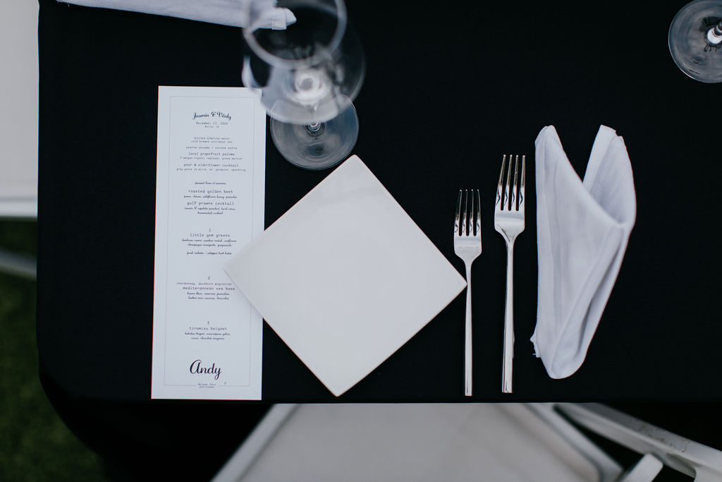 black and white place setting with menu 