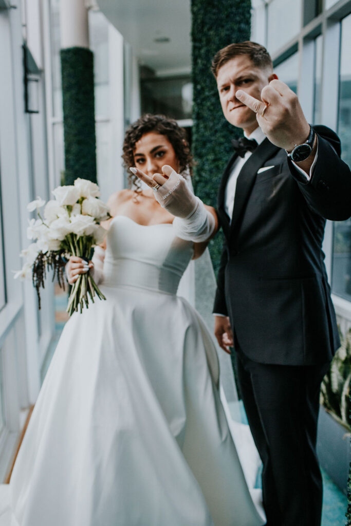 Unleash the Magic: Why Your First Look Should Steal the Show. Bride and Groom flipping off camera 