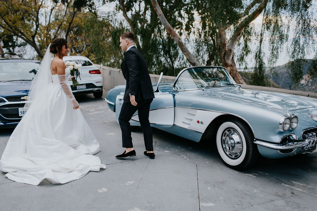 Unleash the Magic: Why Your First Look Should Steal the Show. Grooming holding car door open for bride