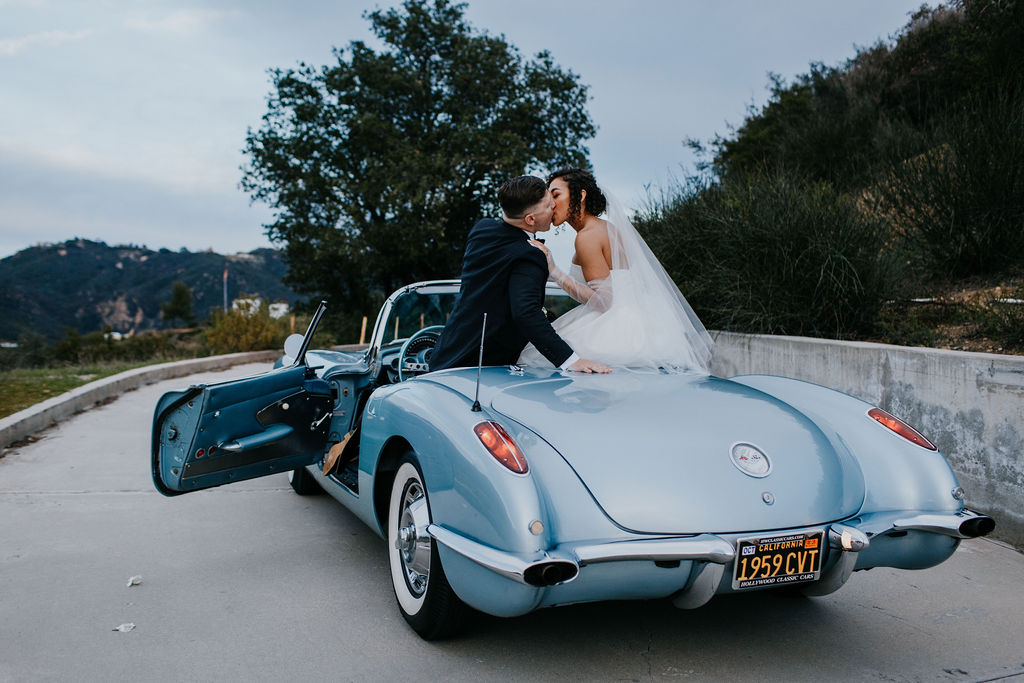 Unleash the Magic: Why Your First Look Should Steal the Show. Bride and groom kissing on car 